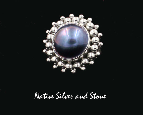 Artie Yellowhorse - Navajo<br>1-1/8" Ring<br>17mm Dark Grey-Blue<br>Mabe Pearl<br>Burst Bead<br>Sterling Silver<br>Size 8