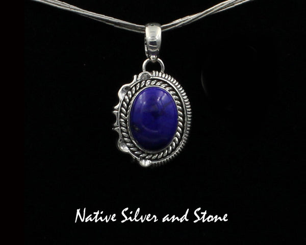 Z Artie Yellowhorse - Navajo<br>PDLTSC<br>1"H Pendant<br>16mm x 12mm Lapis Lazuli Vertical Oval<br>Twist & Single Straight Sawcut with Pinches<br>Sterling Silver
