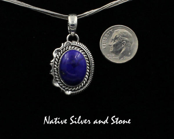 Z Artie Yellowhorse - Navajo<br>PDLTSC<br>1"H Pendant<br>16mm x 12mm Lapis Lazuli Vertical Oval<br>Twist & Single Straight Sawcut with Pinches<br>Sterling Silver