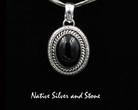 Artie Yellowhorse - Navajo<br>PDOTSSC<br>1"H Pendant<br>16mm x 12mm Onyx Vertical Oval<br>Single Twist & Straight Sawcut<br>Sterling Silver