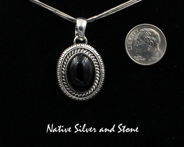 Artie Yellowhorse - Navajo<br>PDOTSSC<br>1"H Pendant<br>16mm x 12mm Onyx Vertical Oval<br>Single Twist & Straight Sawcut<br>Sterling Silver