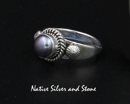 Z Artie Yellowhorse - Navajo<br>9/16" Ring<br>7+mm Round Med Dark Grey Pearl<br>Single Twist Perimeter<br>Shots on Flanks<br>Sterling Silver Sizes: Out of Stock