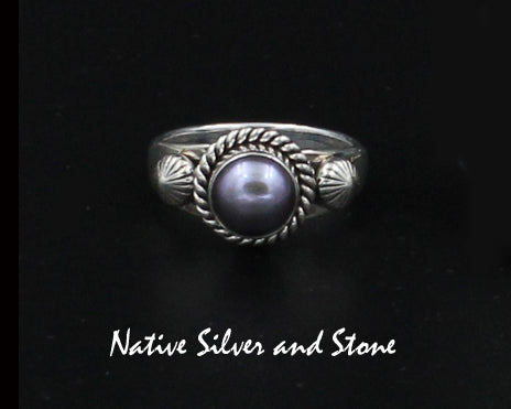 Z Artie Yellowhorse - Navajo<br>9/16" Ring<br>7+mm Round Med Dark Grey Pearl<br>Single Twist Perimeter<br>Shots on Flanks<br>Sterling Silver Sizes: Out of Stock