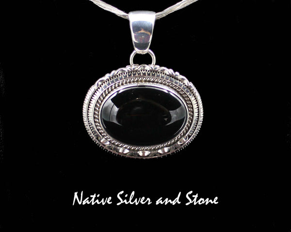 Z Artie Yellowhorse - Navajo<br>POTDSCP<br>1-3/8" Pendant<br>Black Onyx<br>Horizontal Oval (Medium) <br>Single Twist & Double Sawcut w Pinches<br>Sterling Silver