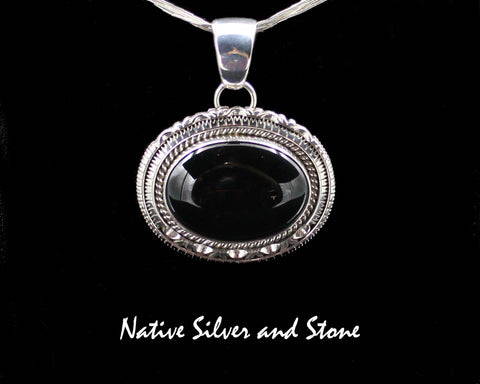 Z Artie Yellowhorse - Navajo<br>POTDSCP<br>1-3/8" Pendant<br>Black Onyx<br>Horizontal Oval (Medium) <br>Single Twist & Double Sawcut w Pinches<br>Sterling Silver