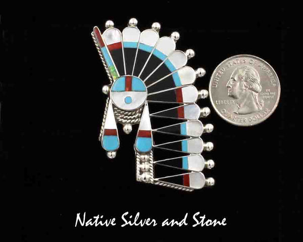 Z Fabian Cellicion- Zuni<br>Pendant/Pin - Inlaid<br>Large Sunface with Offset Headdress<br>Turquoise, White Mother of Pearl, Coral, and Jet<br>w Sterling Silver Accent