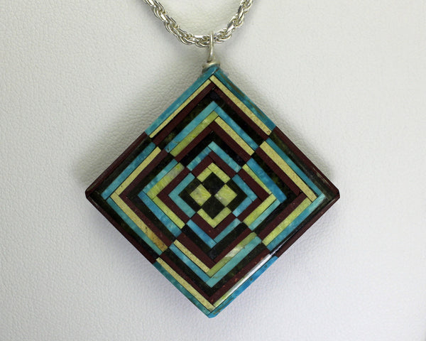 Eugene & Georgia Sanchez<br>Kewa (Santo Domingo)<br>Optical Illusion Inlay Pendant<br>Turquoise, Serpentine, Jet, and Pipestone.