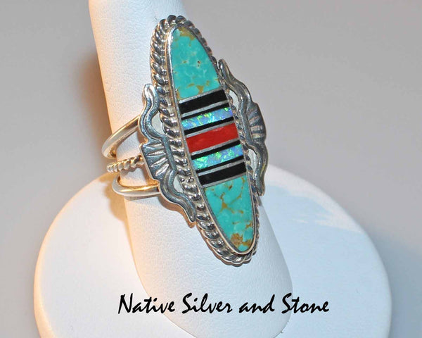 Nataanii (John Charley) - Navajo<br>1-1/2" Ring<br>Multi-Inlay Long Oval<br>Green Turquoise, Onyx, Coral, Opal<br>Size 8