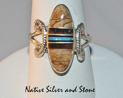 Nataanii  (John Charley) - Navajo<br>Ring<br>Multi-Inlay Short Oval<br>Picture Jasper, Tiger Eye, Onyx, Opal<br>Size 8-1/4