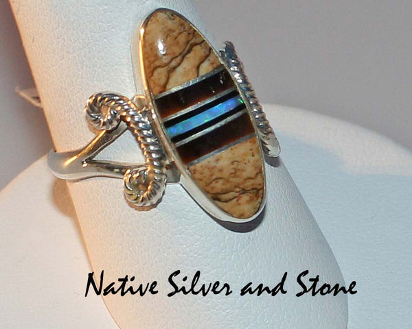 Nataanii  (John Charley) - Navajo<br>Ring<br>Multi-Inlay Short Oval<br>Picture Jasper, Tiger Eye, Onyx, Opal<br>Size 8-1/4