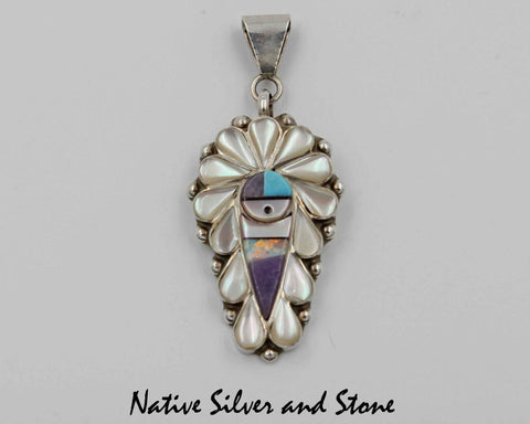 Z Stanford Gchachu & Geraldine Gchachu<br>Zuni Pendant<br>1 Medium-Large<br>Sun Face Multi-Inlay<br>White Mother of Pearl, Sodalite, Turquoise,  Jet, and<br>Opal