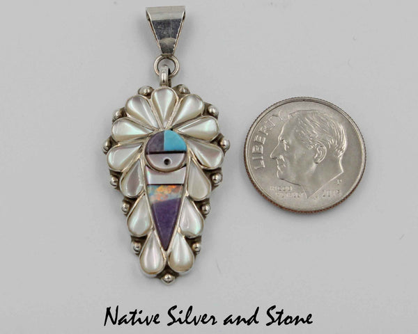 Z Stanford Gchachu & Geraldine Gchachu<br>Zuni Pendant<br>1 Medium-Large<br>Sun Face Multi-Inlay<br>White Mother of Pearl, Sodalite, Turquoise,  Jet, and<br>Opal